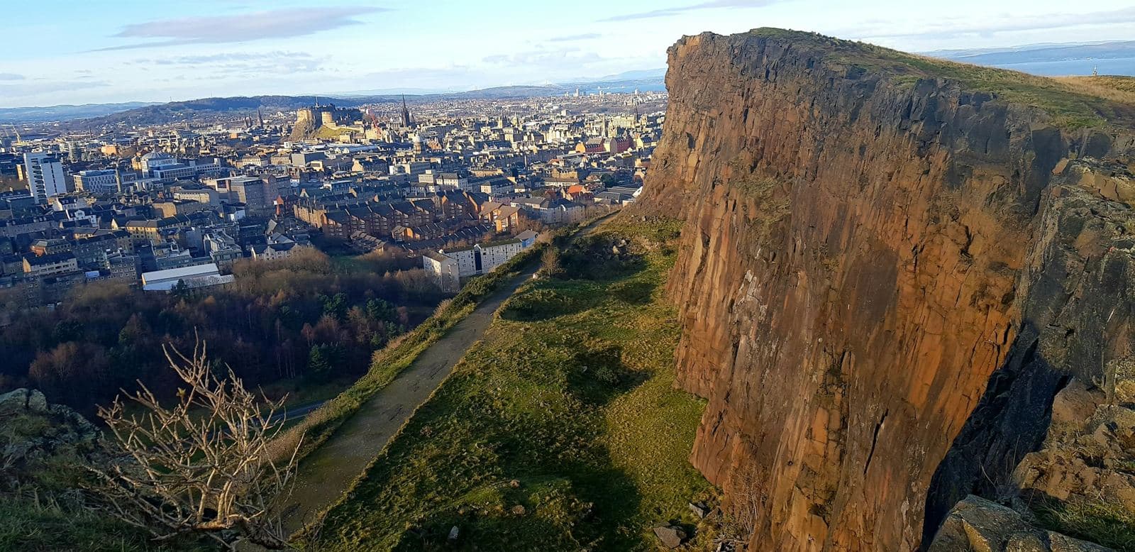 Edinburgh skyline seen from a hilltop above the Old Town, the setting for the Edinburgh Festival Fringe. Photo by Katherine Carlyon on Unsplash.